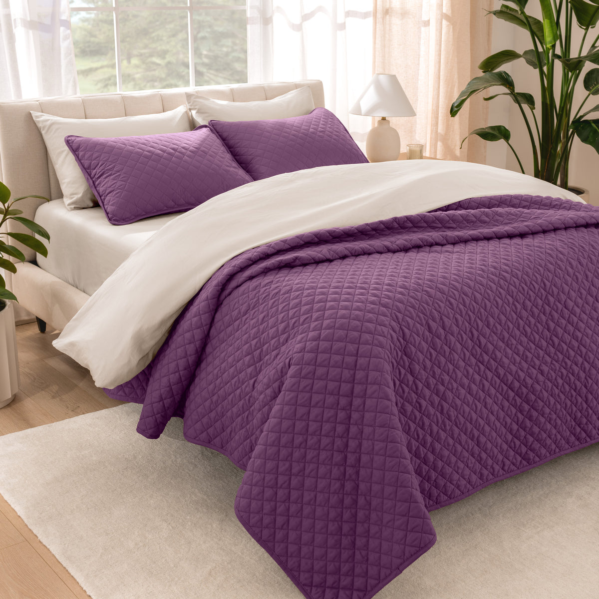 Bedroom showing coverlet set laying on the bed with the quilt folded over on itself