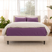 A bright bedroom with a coverlet set on the bed