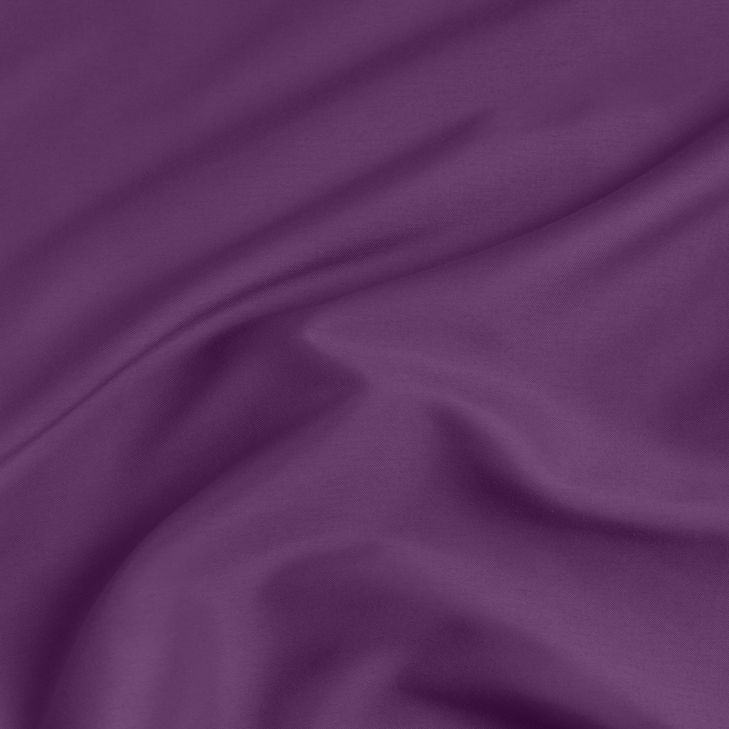 A close-up of a fitted sheet with a label printed with the word 'BOTTOM' in white.