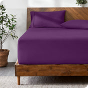 Wooden bed with ultra soft bedding in a minimalistic room.