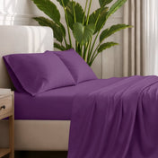 Ultra-soft sheets and pillowcases on a bed with a plant in the background