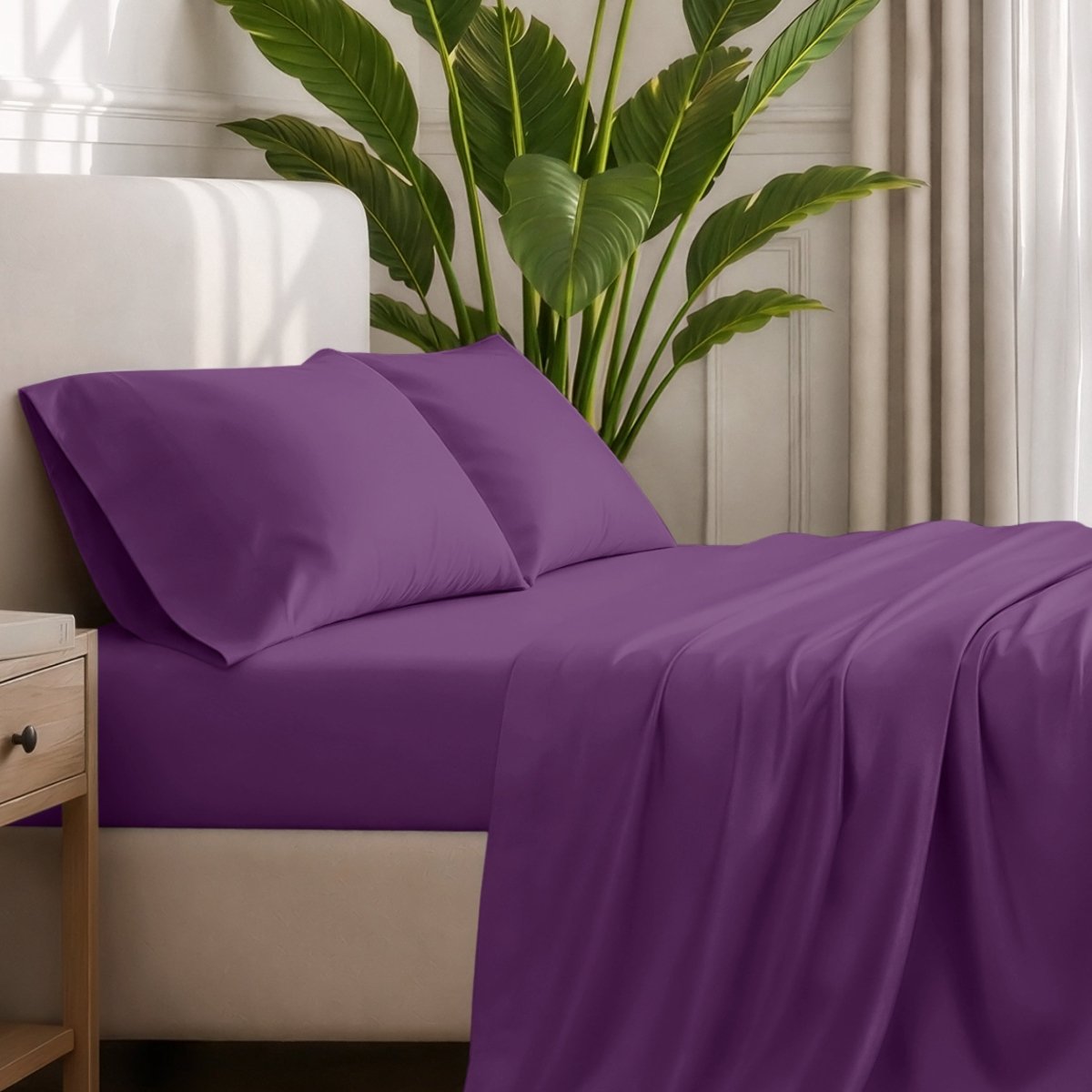 Ultra-soft sheets and pillowcases on a bed with a plant in the background