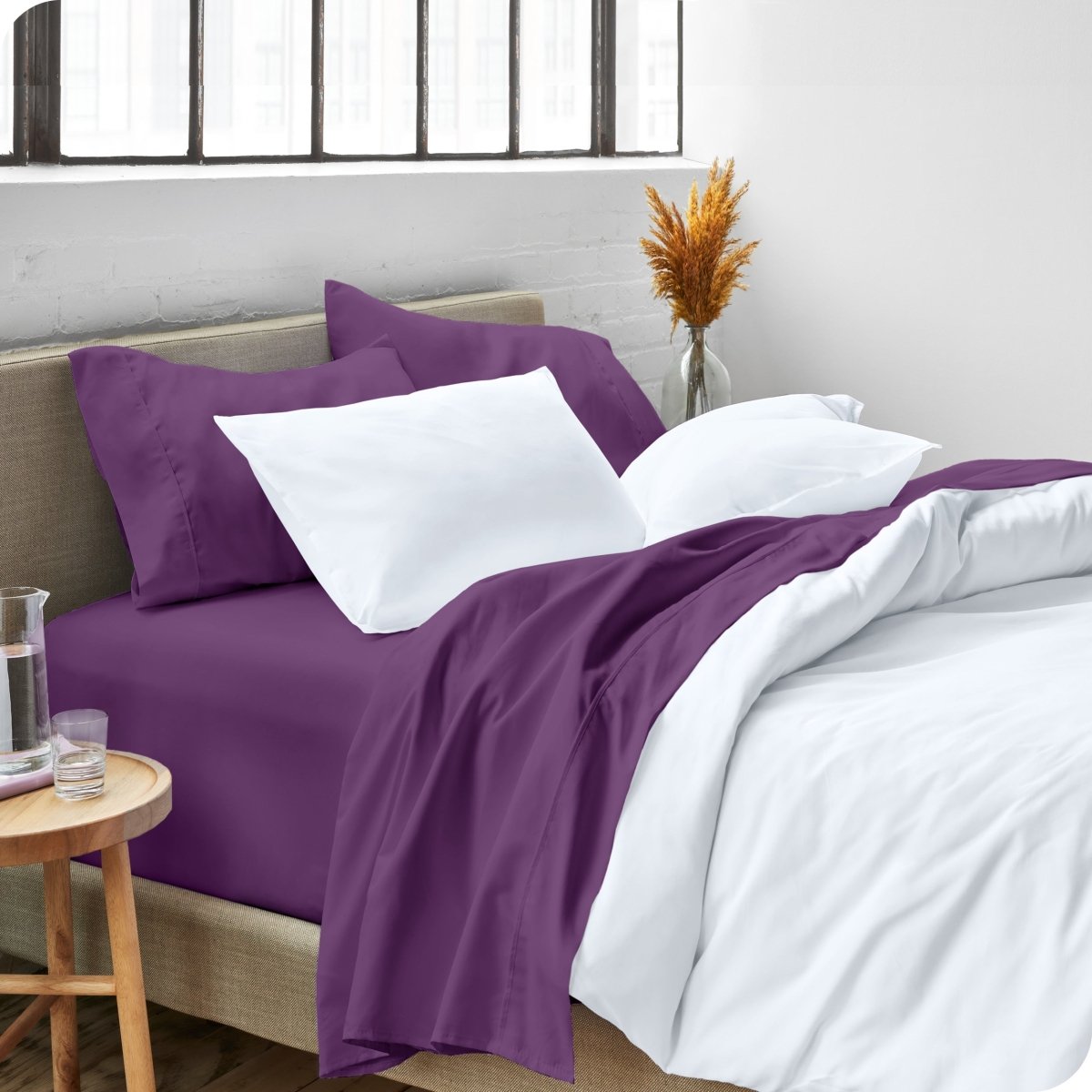 A side view of a bed made with microfiber sheets and a white duvet cover