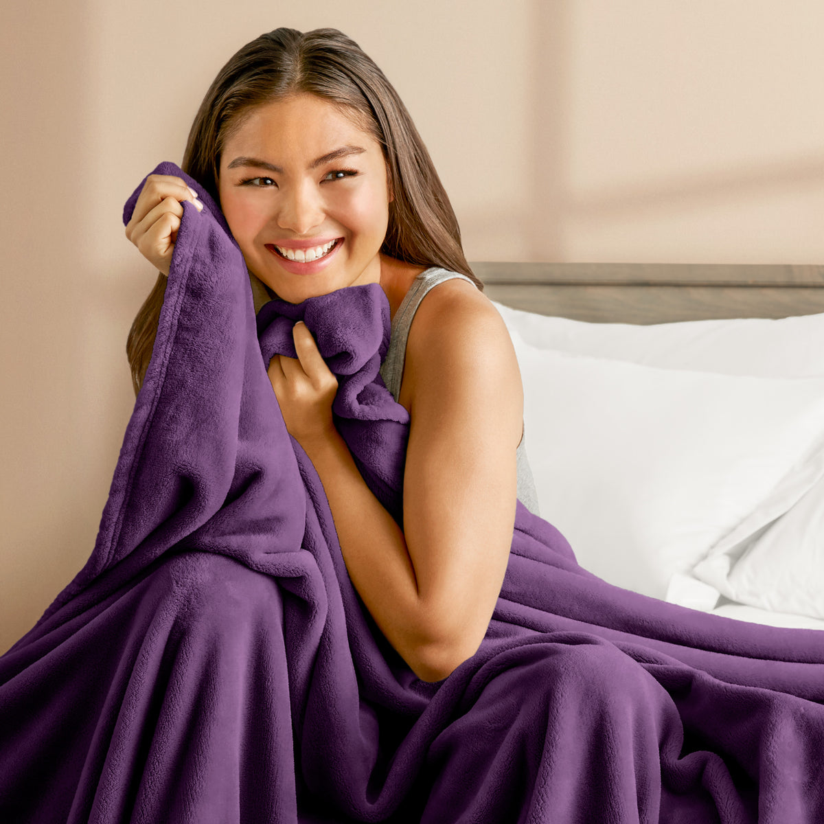 A woman cuddling with a microplush blanket