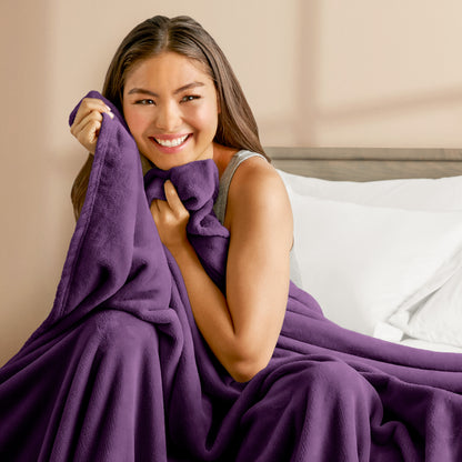 A woman cuddling with a microplush blanket