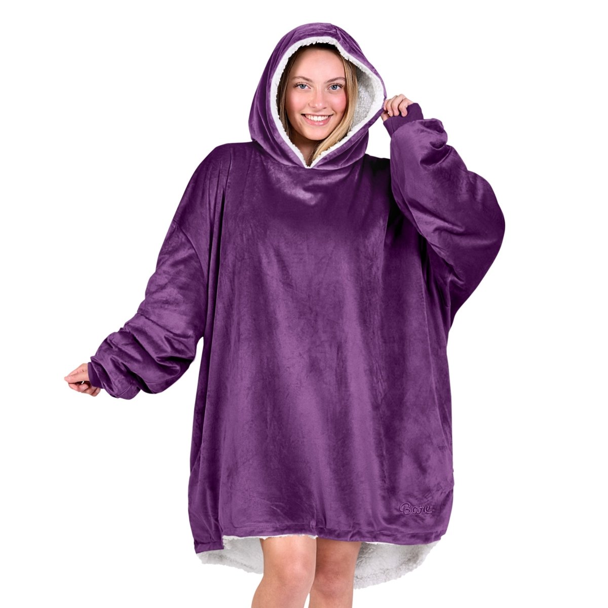 An adult with a sherpa wearable blanket on