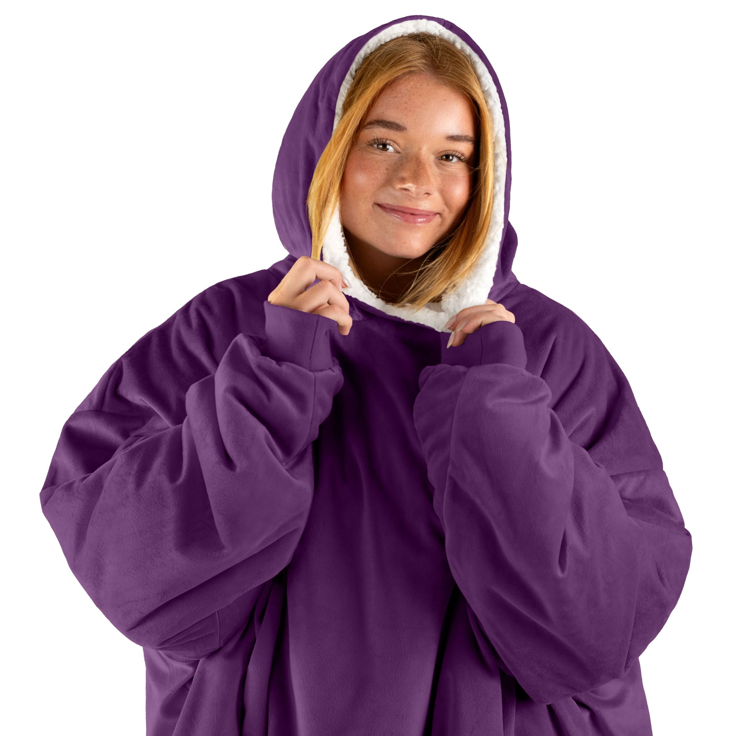 An adult with a wearable blanket on