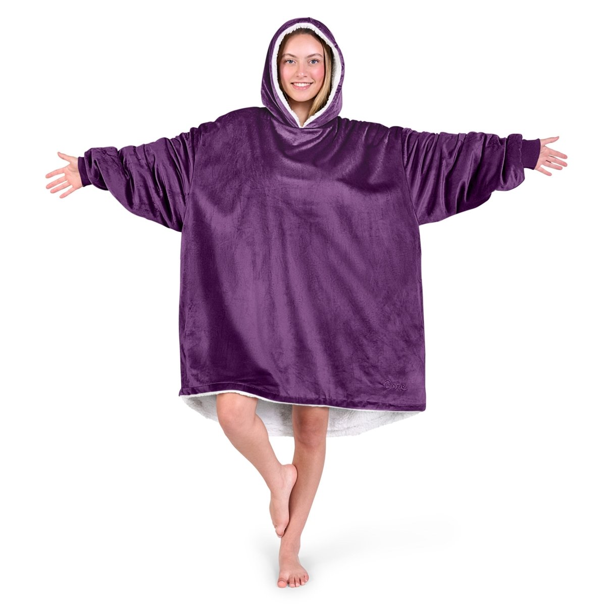 An adult with a sherpa wearable blanket on