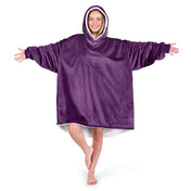 An adult with a sherpa wearable blanket on