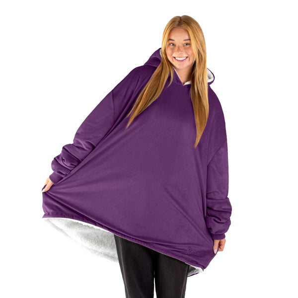 An adult with a sherpa wearable blanket on