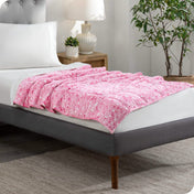 A weighted blanket laid out on a bed.