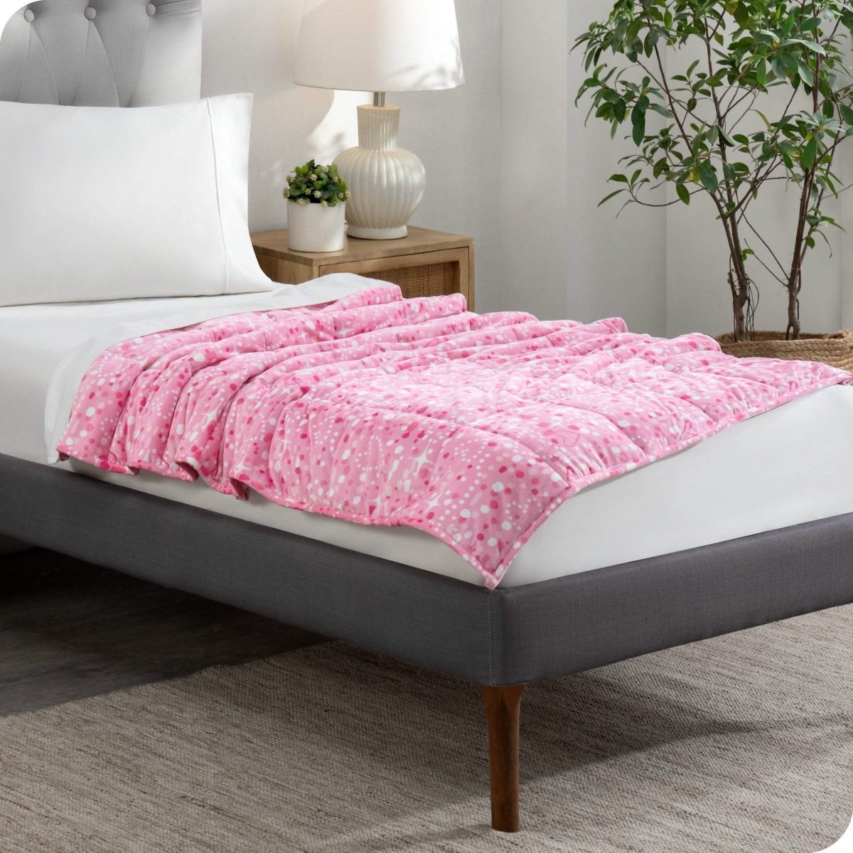 A weighted blanket laid out on a bed.
