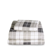 Stack of flannel sheets and pillowcases on a white background