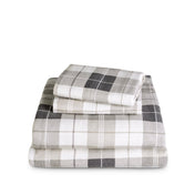 Stack of flannel sheets and pillowcases on a white background