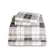 Stack of flannel sheets and pillowcases on a white background