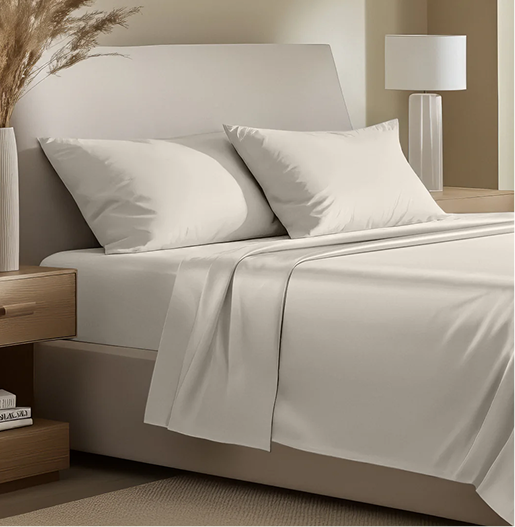 Neatly made bed with white bedding in a bedroom setting.