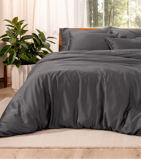 Gray bedding set on a bed with a plant and window in the background review