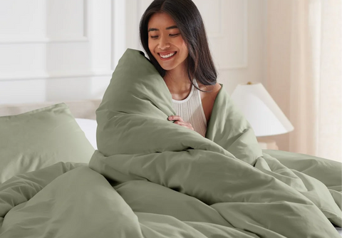 Woman wrapped in a gray blanket, cozy portrait