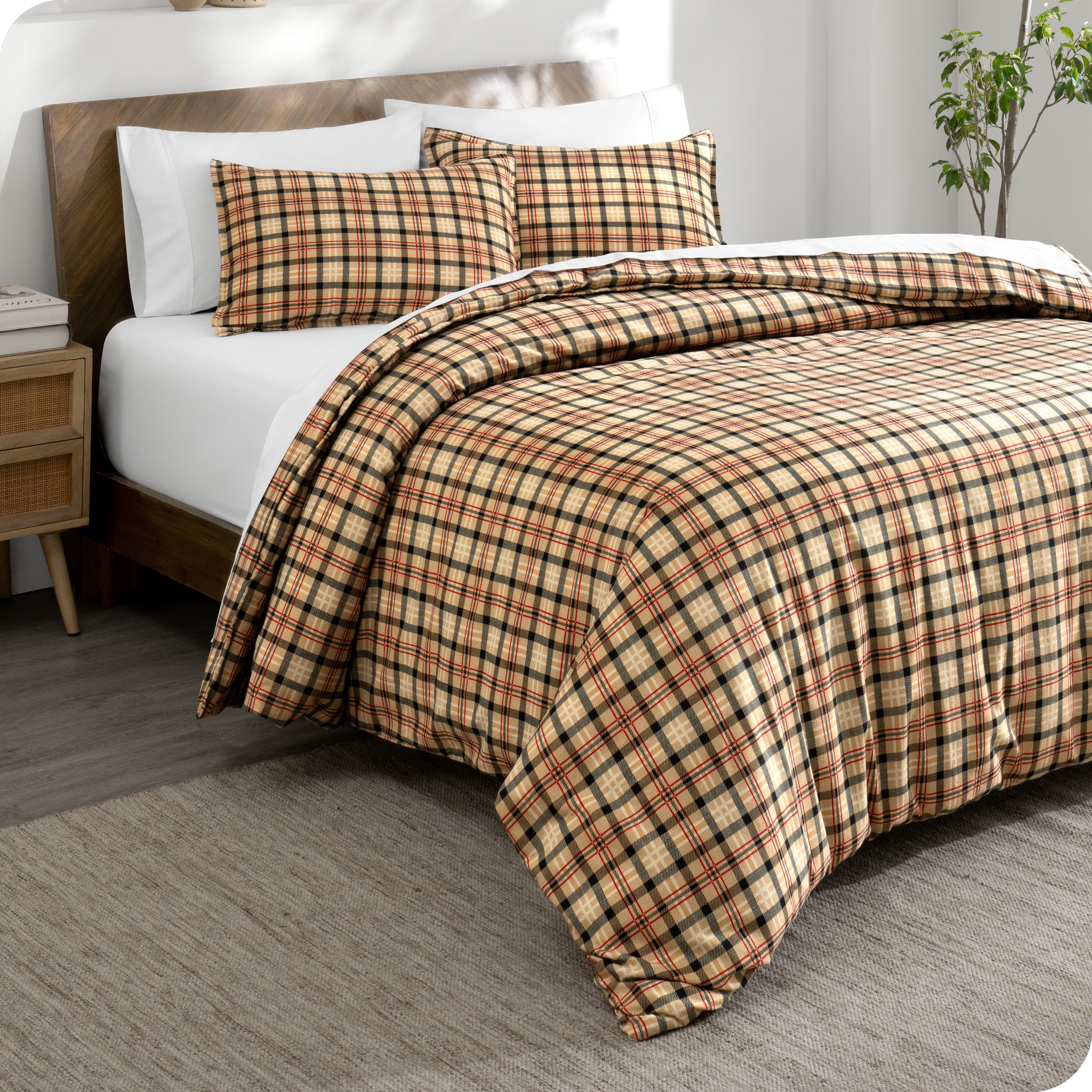 Plaid duvet cover and shams laid out on a bed