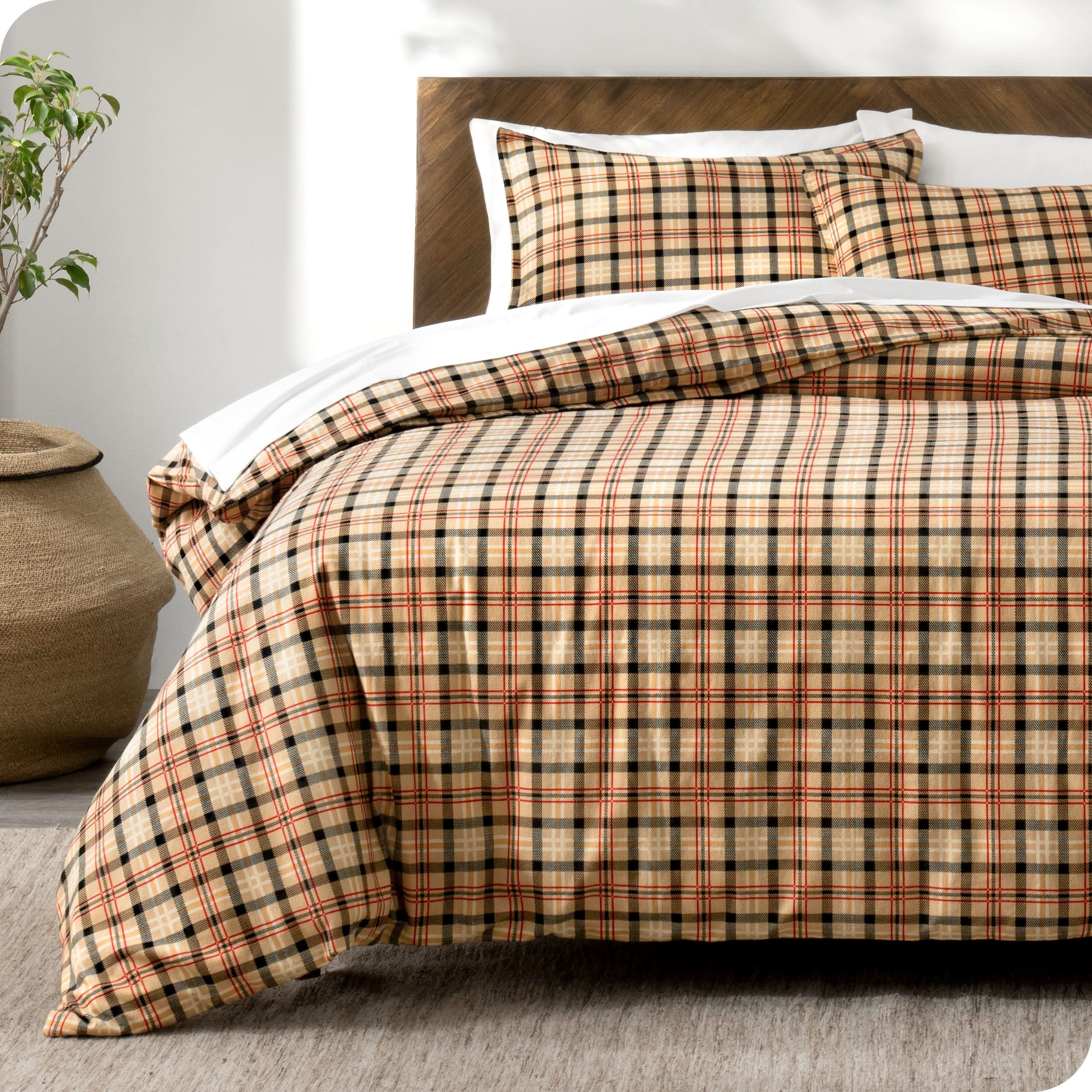 Plaid duvet cover and shams laid out on a bed