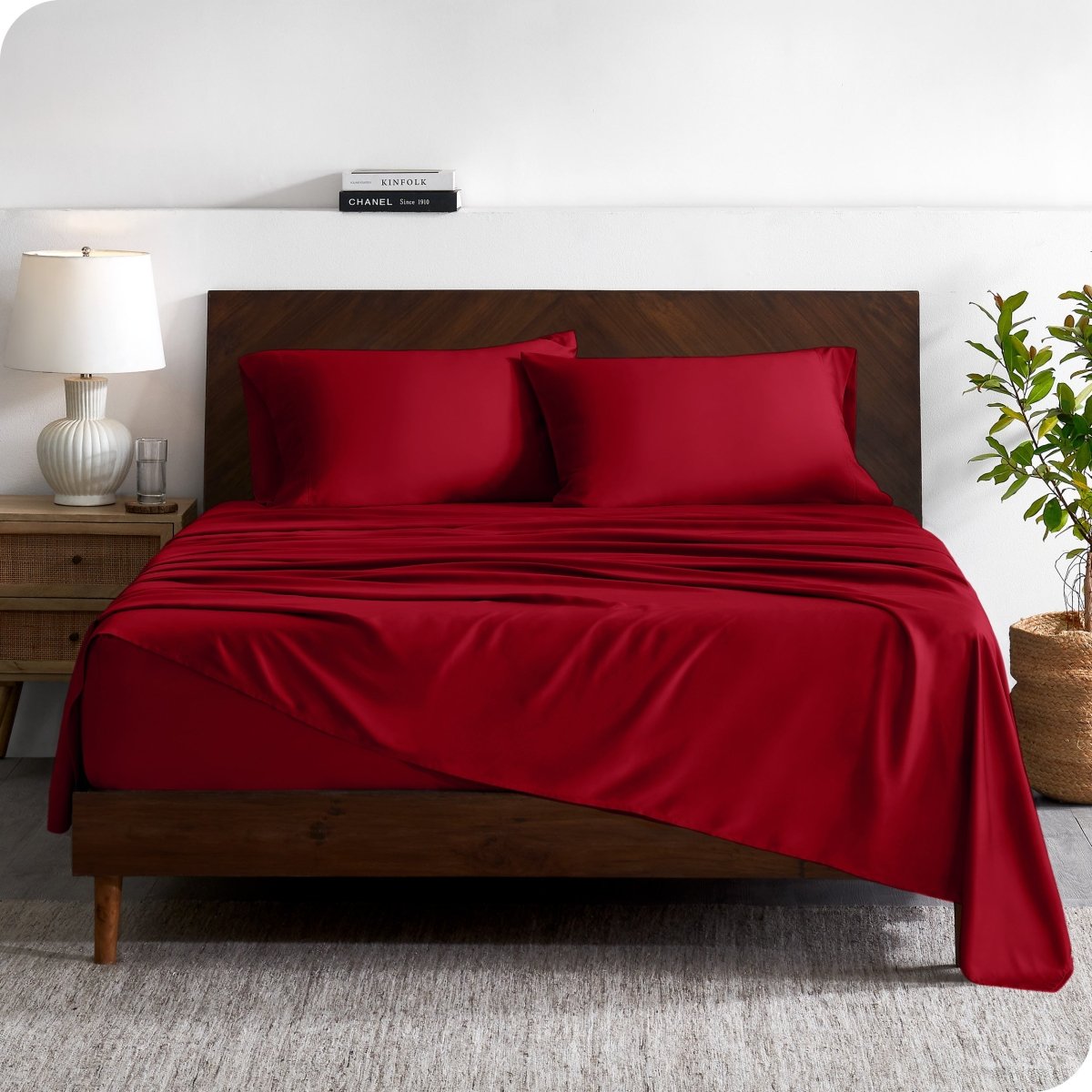 A contemporary bed with a sheet set and a wooden headboard.