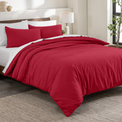 Flannel duvet cover set on a bed in a bedroom with a lamp and plant in the background.