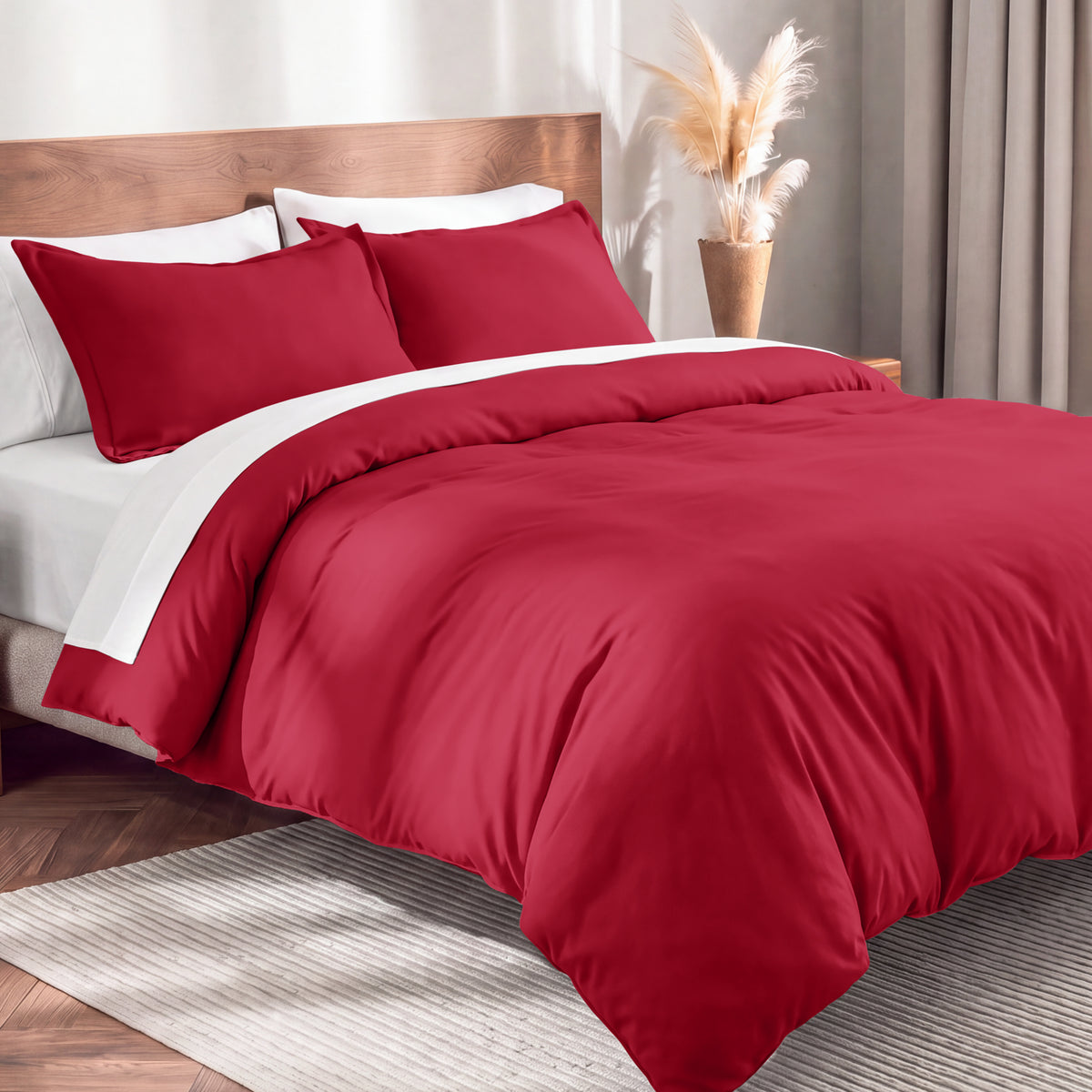 Flannel duvet cover set on a bed in a bedroom with a lamp and plant in the background.