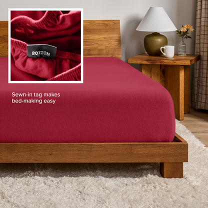 A flannel fitted sheet on a mattress with a wooden bed frame