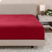 A close up of a modern bed with a flannel fitted sheet on