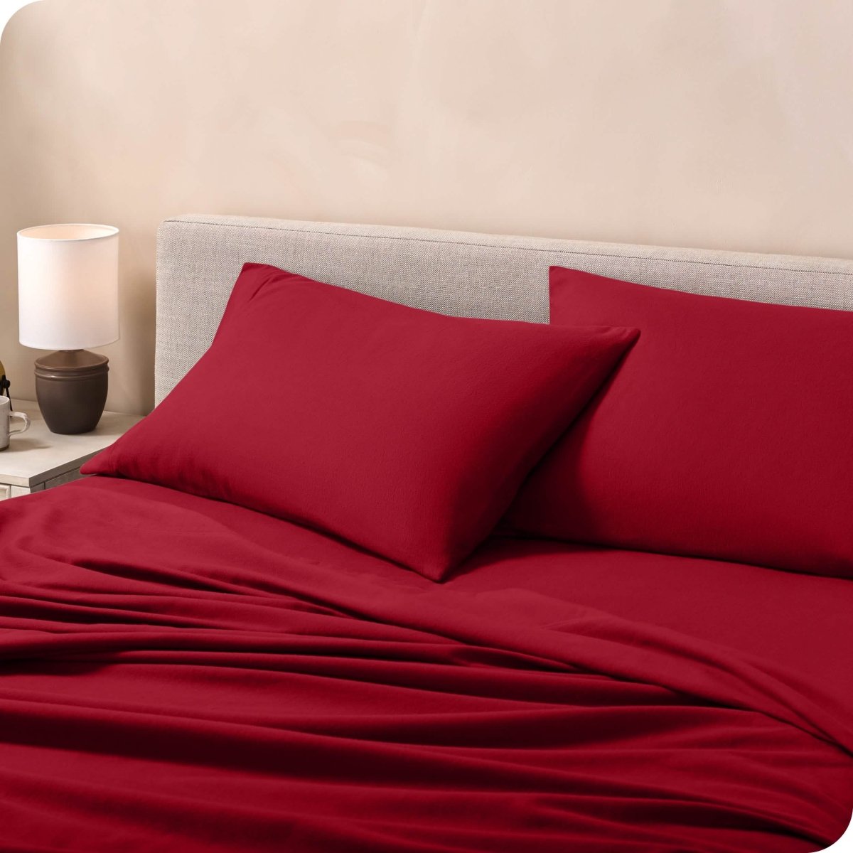 Flannel pillowcases on a mattress leaning against the headboard