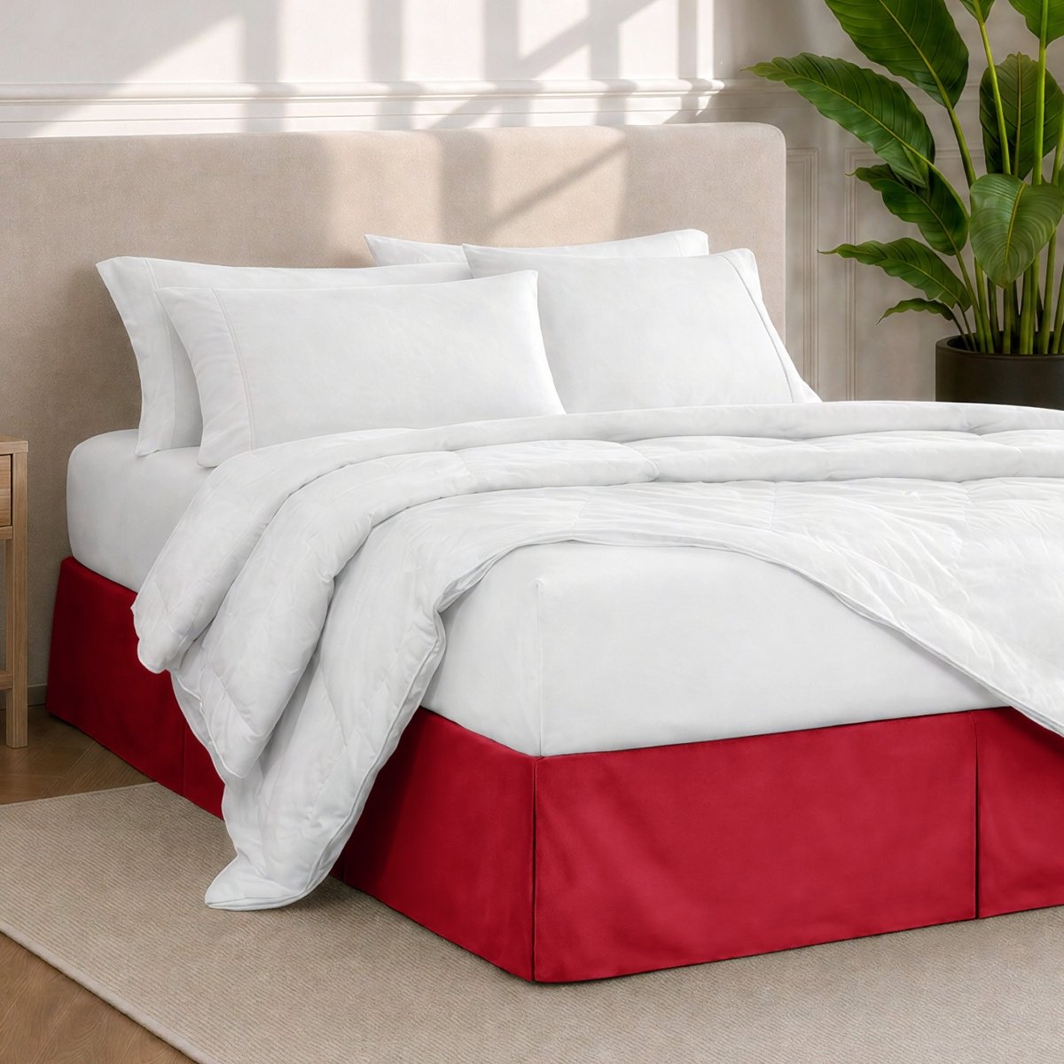 A modern bedroom with a bed skirt, comforter and sheets on the bed