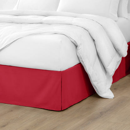 Microfiber bed skirt on a bed with white bedding and wooden floor.