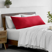 Bed with microfiber bedding and wooden headboard in a bedroom setting