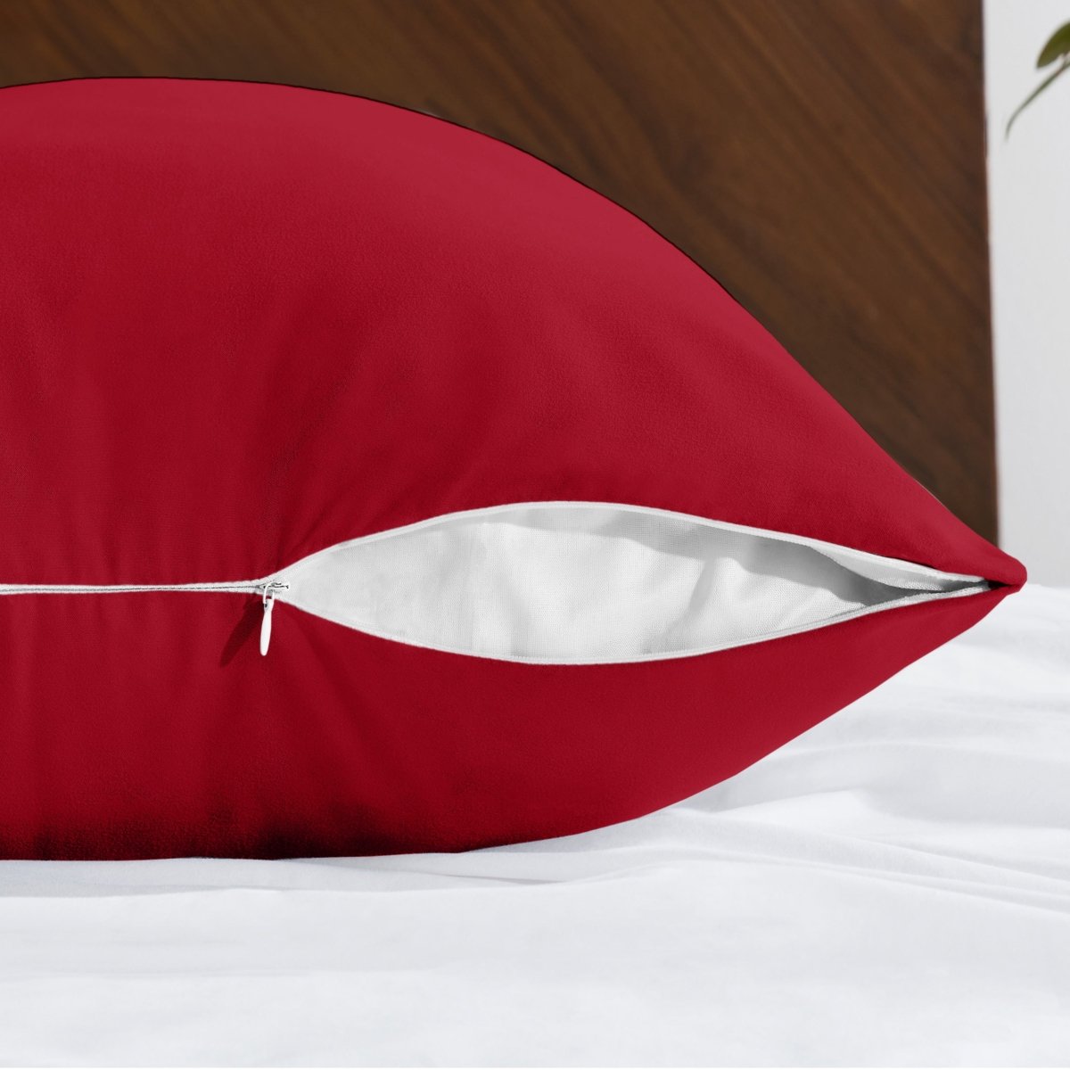 Body pillowcase with a zipper closure on a bed with a wooden headboard