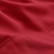 A close-up of microfiber fabric with soft folds and a visible stitched seam.