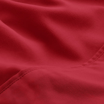 A close-up of microfiber fabric with soft folds and a visible stitched seam.