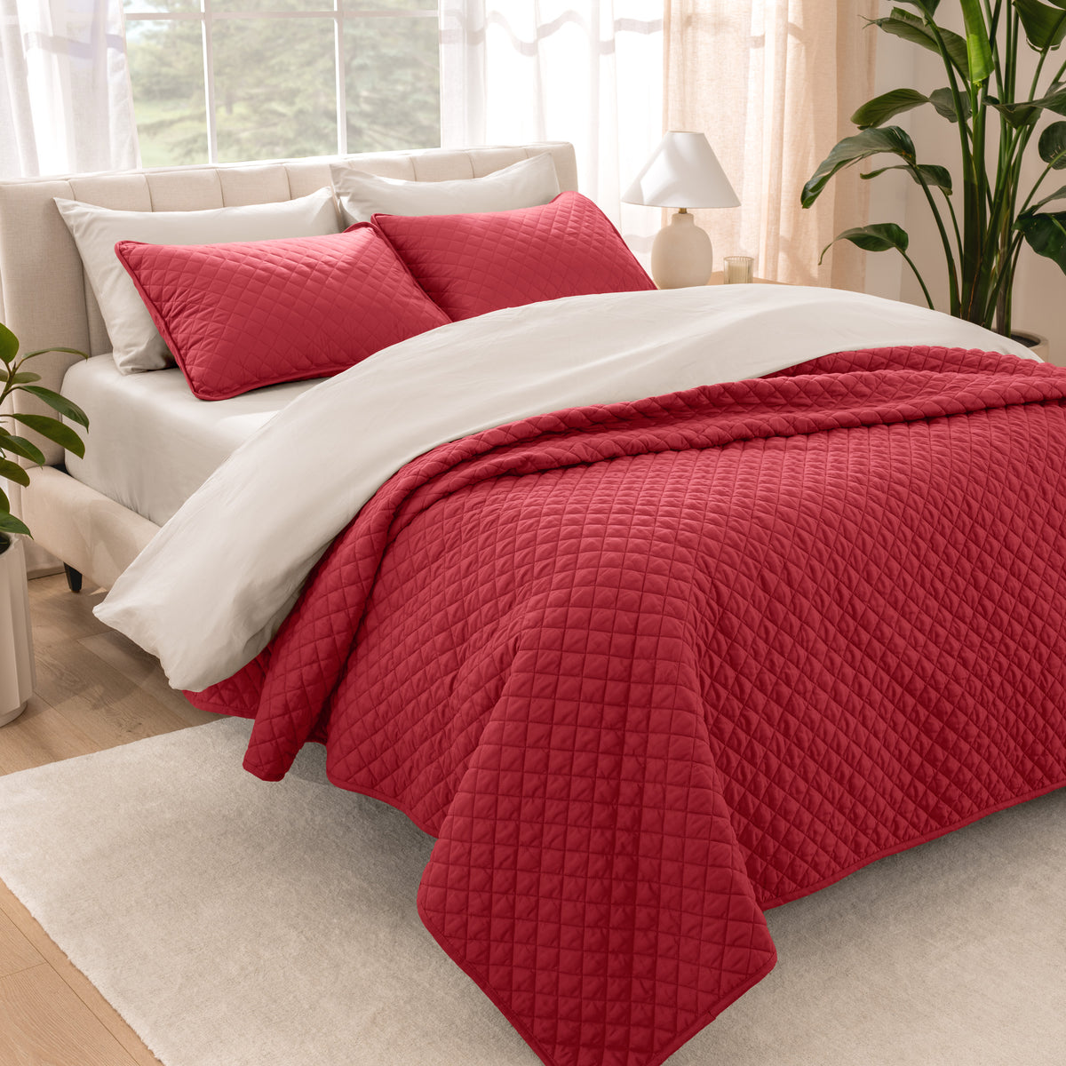 Bedroom showing coverlet set laying on the bed with the quilt folded over on itself
