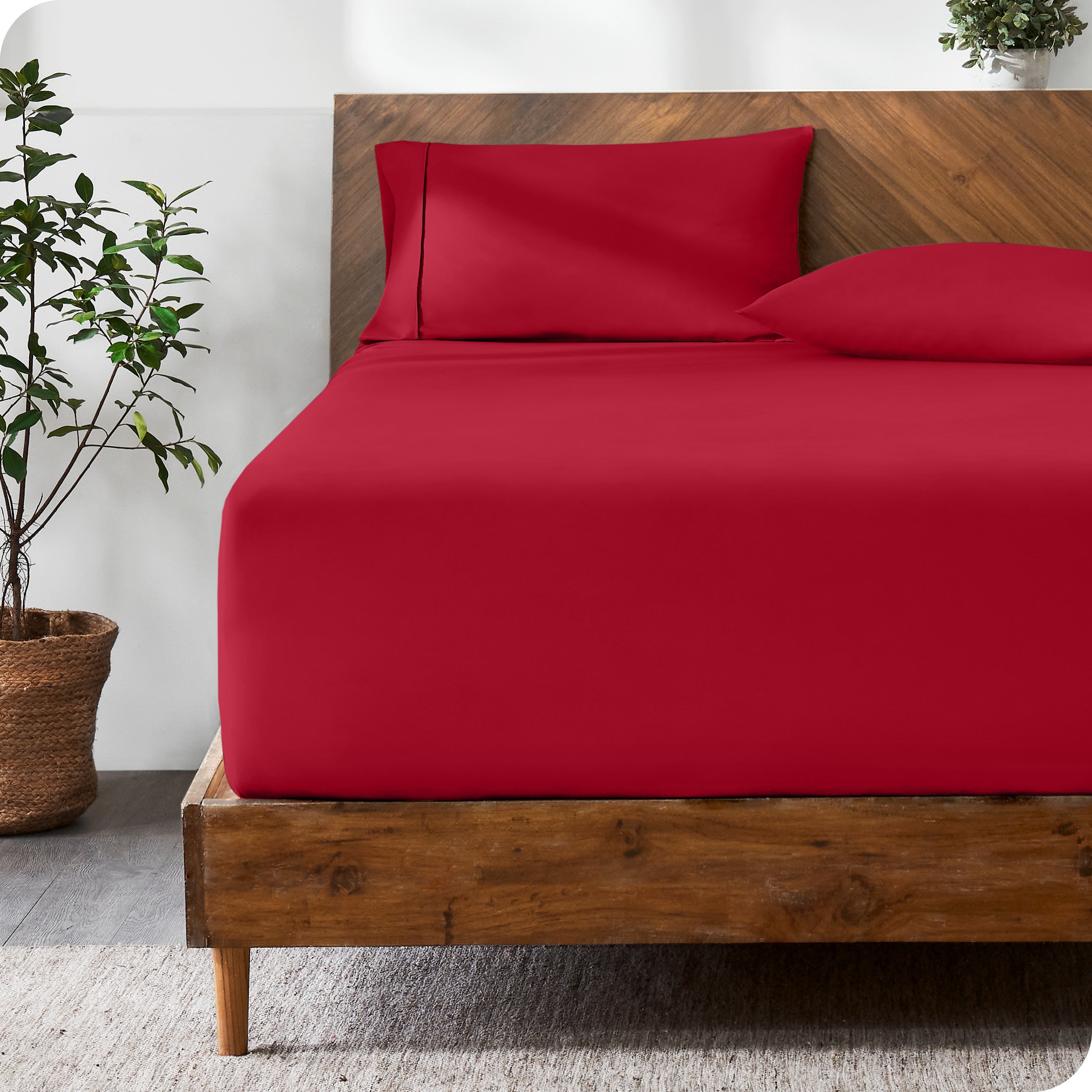Wooden bed with ultra soft bedding in a minimalistic room.