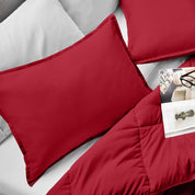 Microfiber pillow sham set on a bed with a magazine on top of the comforter.
