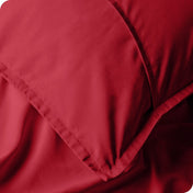 Close up of pillow shams on a bed