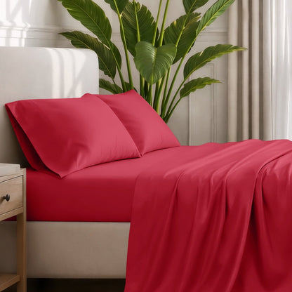 Ultra-soft sheets and pillowcases on a bed with a plant in the background