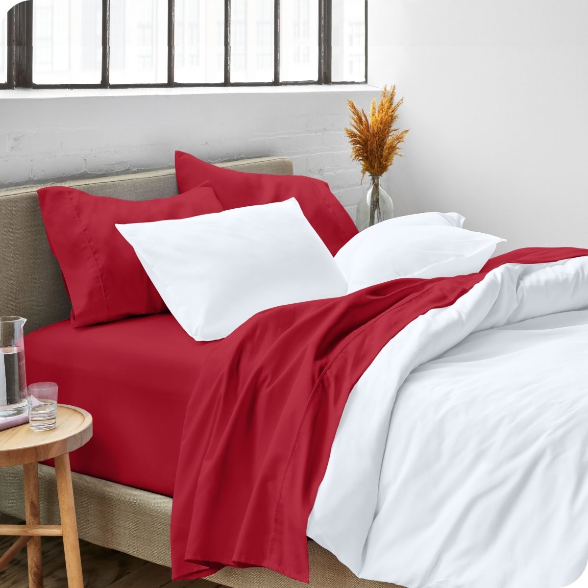A side view of a bed made with microfiber sheets and a white duvet cover
