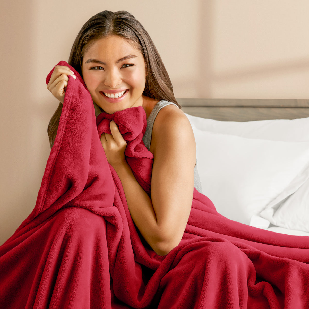 A woman cuddling with a microplush blanket