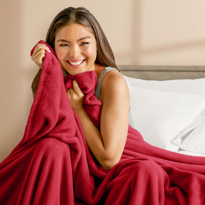 A woman cuddling with a microplush blanket