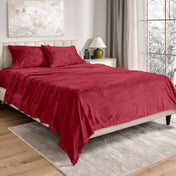 Neatly made bed in a well-lit bedroom.