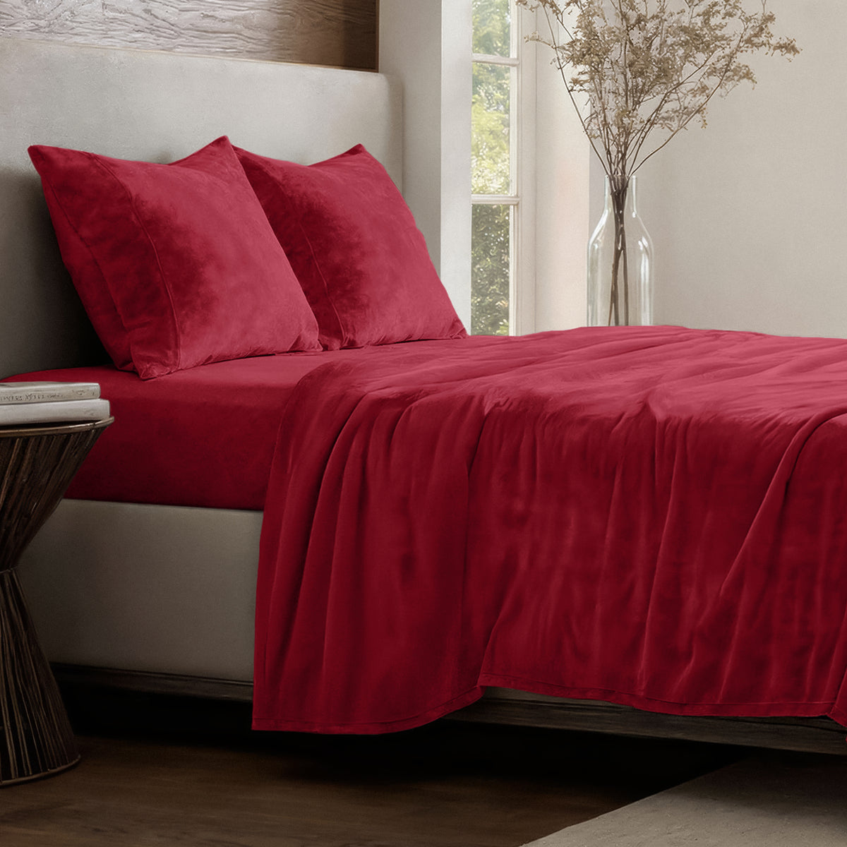 Neatly made bed in a well-lit bedroom.