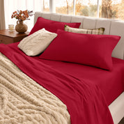 Neatly made bed with organic flannel sheets  and a beige blanket in a bright bedroom.