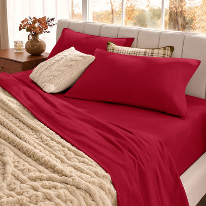 Neatly made bed with organic flannel sheets  and a beige blanket in a bright bedroom.