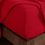 Corner of a mattress with a fitted sheet on it