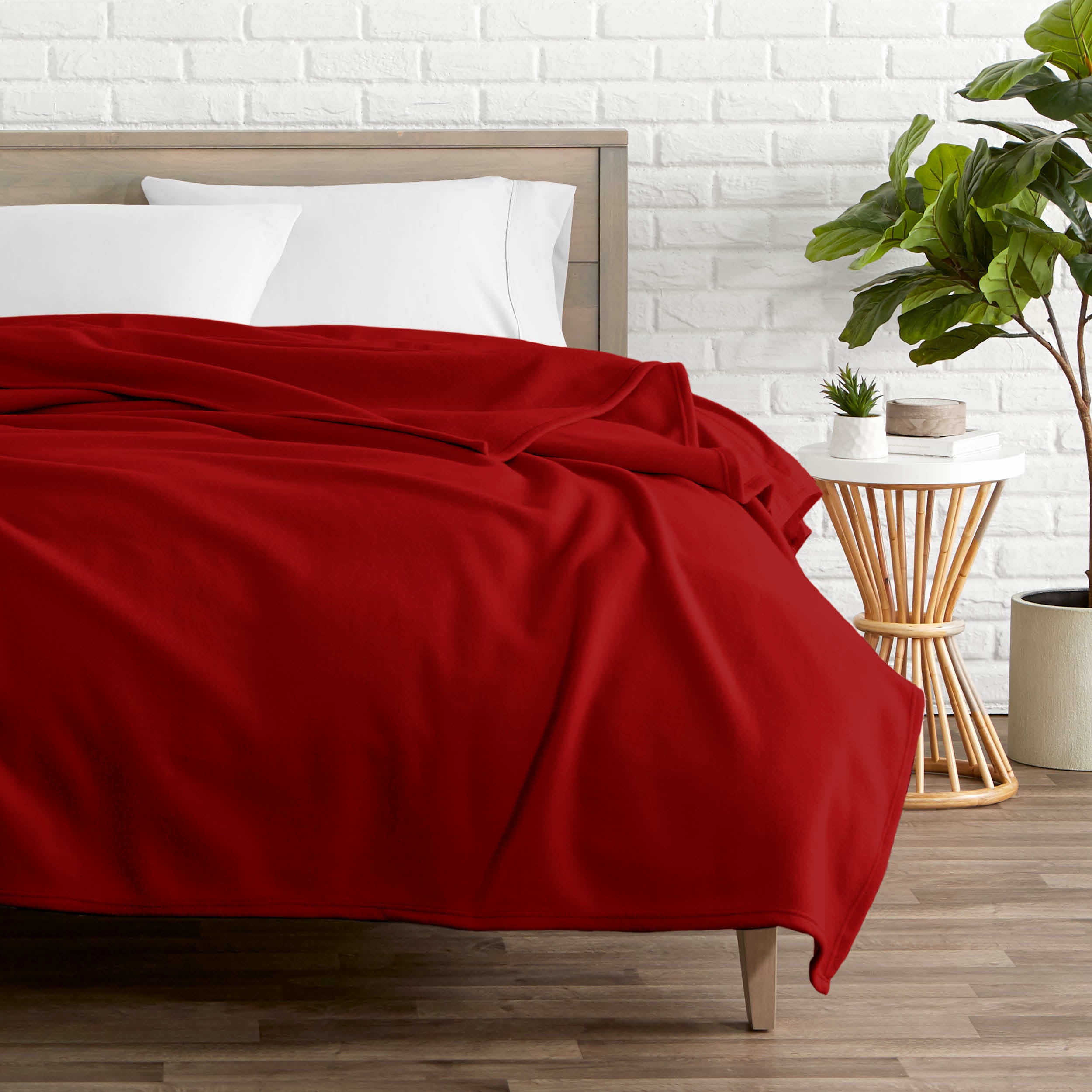 Red polar fleece blanket on a bed